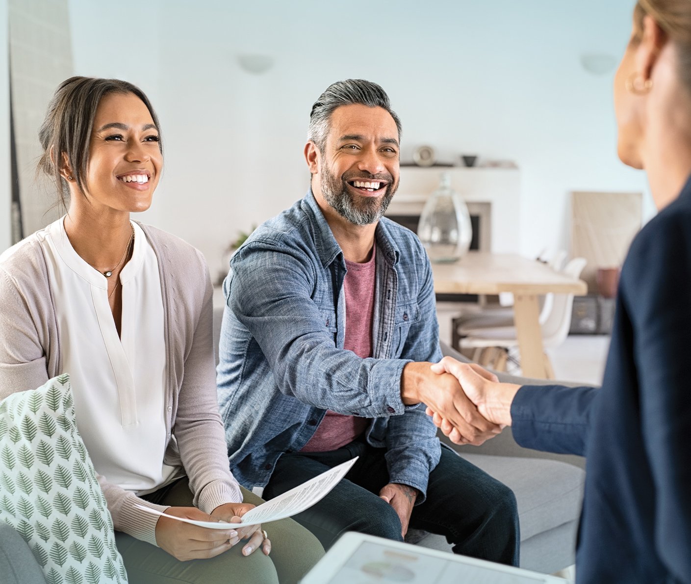 Couple meeting with their financial advisor in an office, discussing investment options